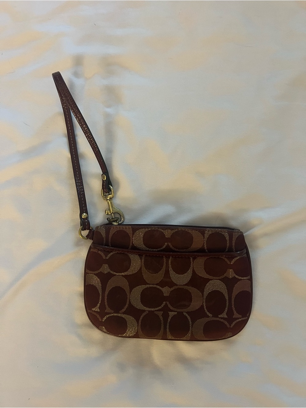 Coach Signature Jacquard Wristlet in a burgundy with gold hardware